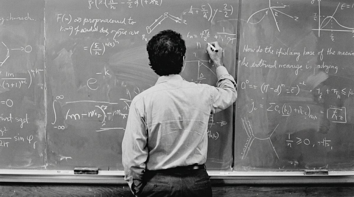 The Feynman Way — a teacher writing physics equations on a chalkboard